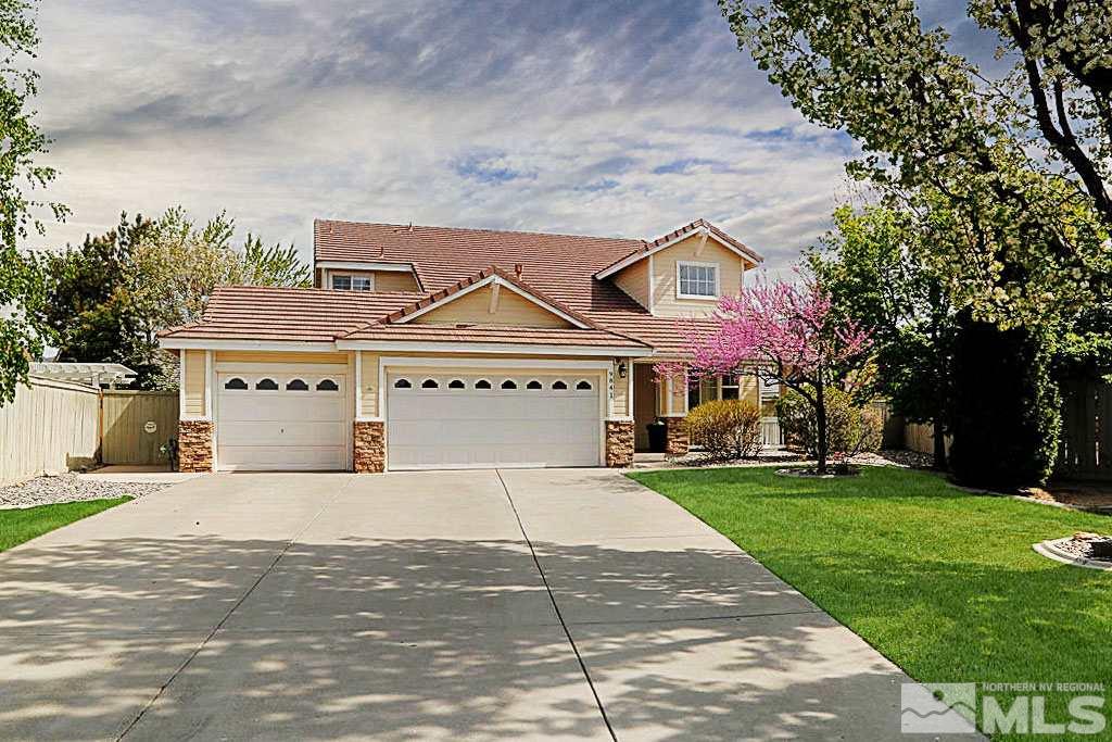9841 Eastmont Court Reno, NV 89521 - Photo 1 of 38 a front view of a house with a garden and trees