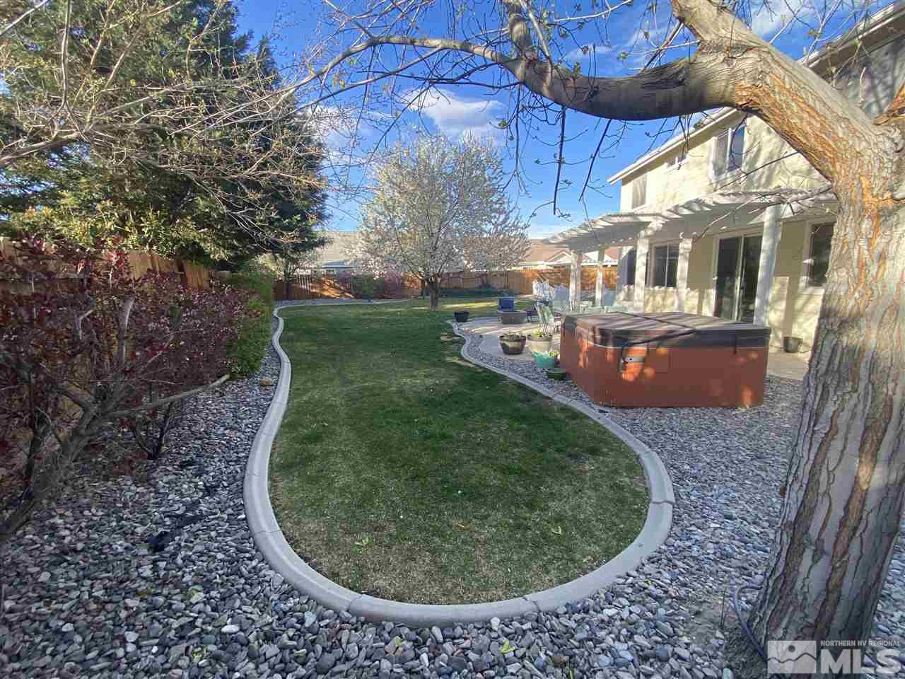 9841 Eastmont Court Reno, NV 89521 - Photo 12 of 38 a view of a backyard with table and chairs