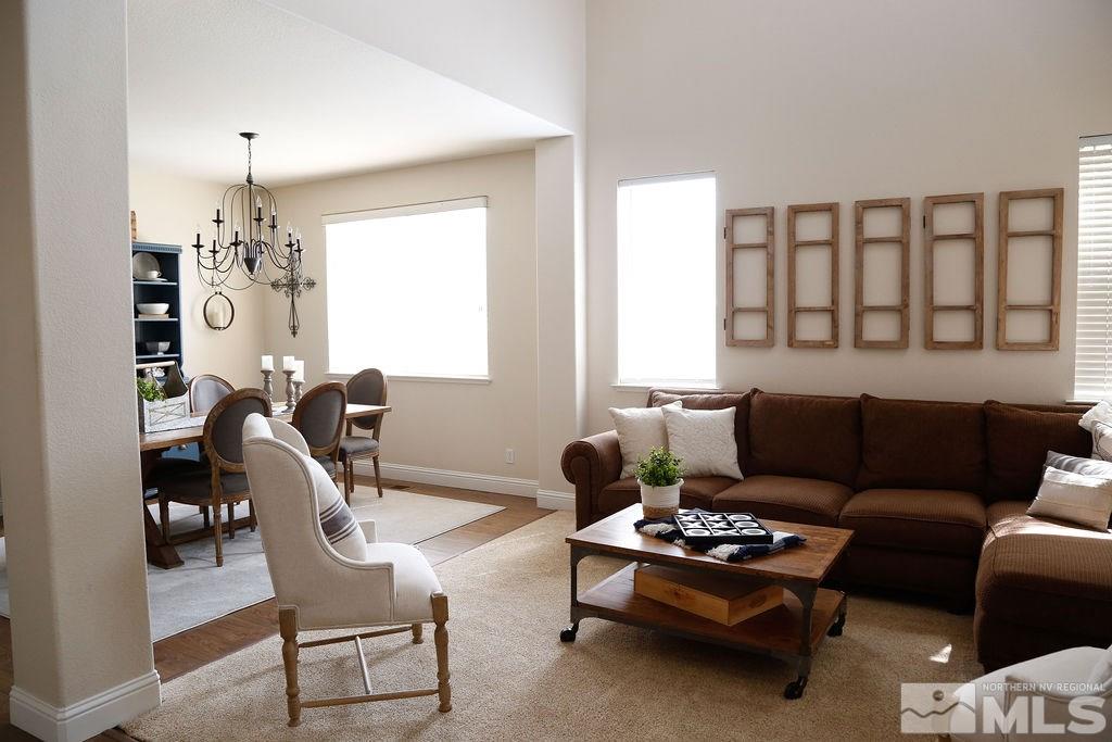 9841 Eastmont Court Reno, NV 89521 - Photo 14 of 38 a living room with furniture and a chandelier