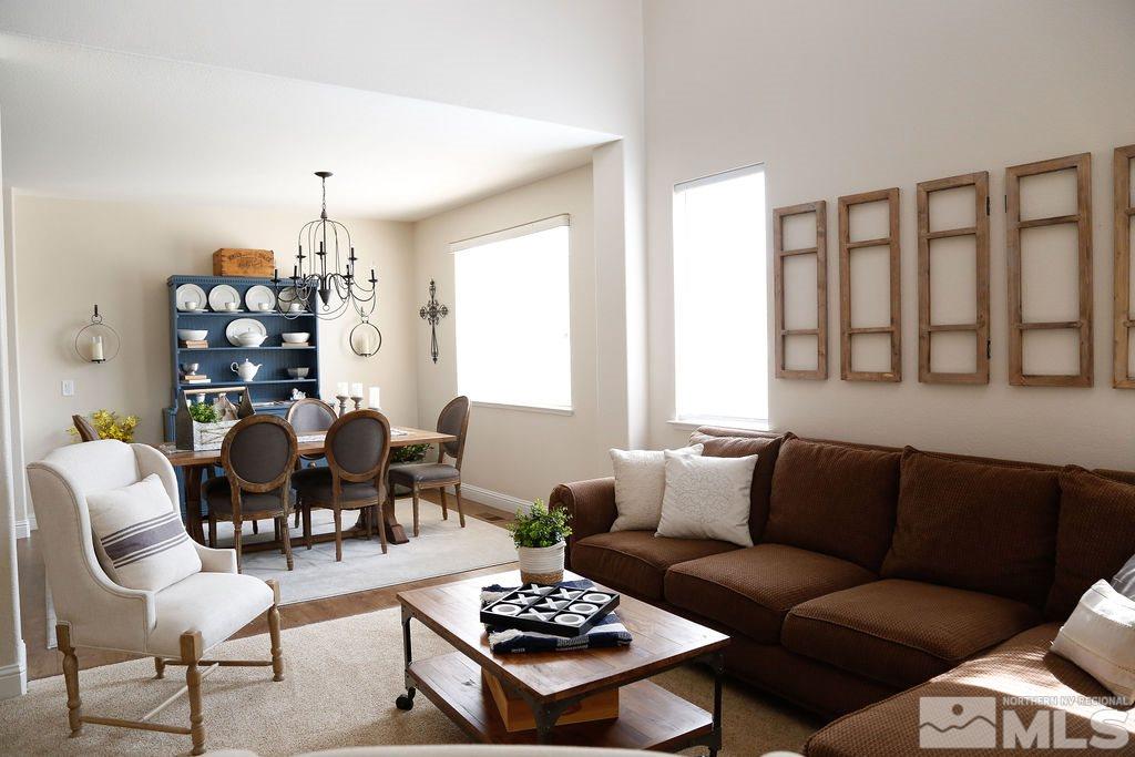 9841 Eastmont Court Reno, NV 89521 - Photo 15 of 38 a living room with furniture a rug and a chandelier