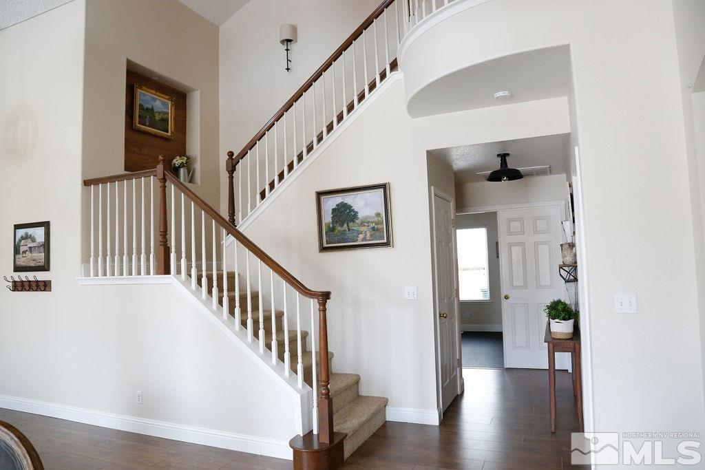 9841 Eastmont Court Reno, NV 89521 - Photo 19 of 38 a view of a hallway with wooden floor and stairs