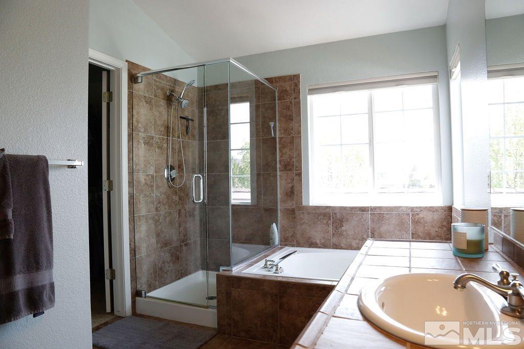 9841 Eastmont Court Reno, NV 89521 - Photo 23 of 38 a bathroom with a bathtub and a shower