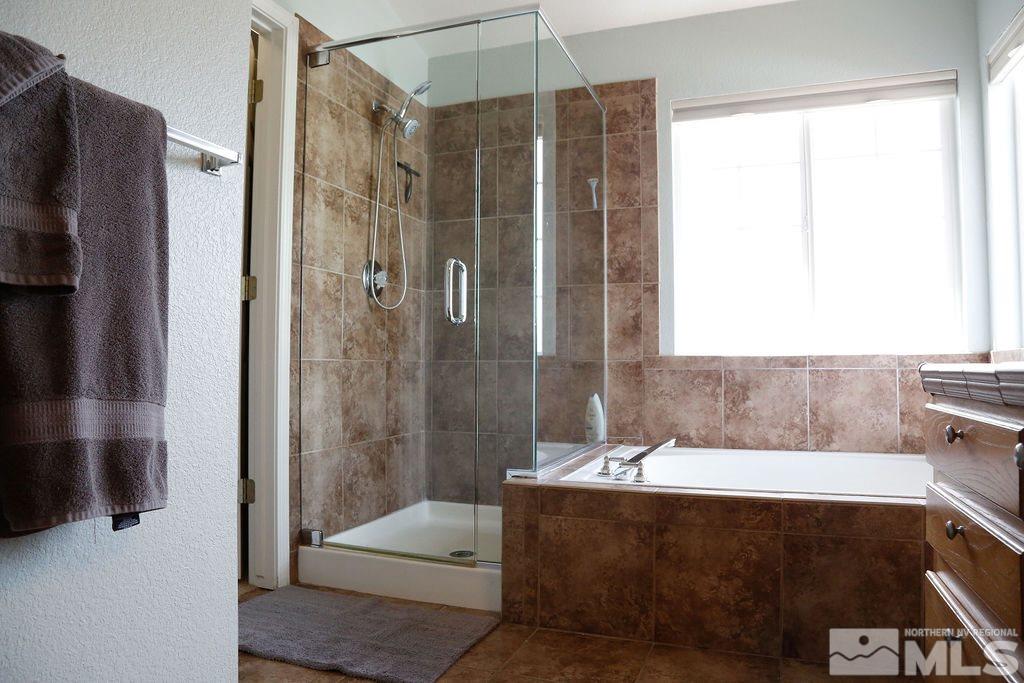 9841 Eastmont Court Reno, NV 89521 - Photo 24 of 38 a bathroom with a tub shower and sink