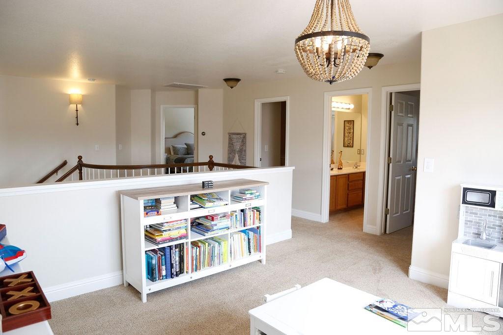 9841 Eastmont Court Reno, NV 89521 - Photo 26 of 38 a room with stainless steel appliances kitchen island a chandelier