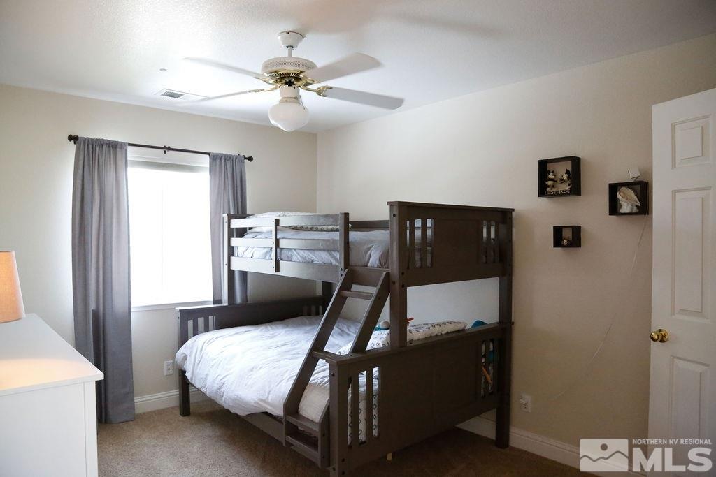 9841 Eastmont Court Reno, NV 89521 - Photo 27 of 38 a bed room with a bed and a lamp