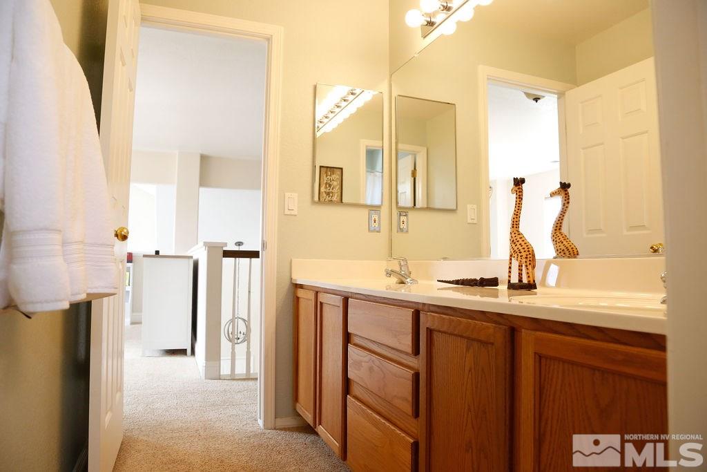 9841 Eastmont Court Reno, NV 89521 - Photo 30 of 38 a bathroom with a double vanity sink and a mirror