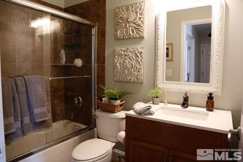 9841 Eastmont Court Reno, NV 89521 - Photo 32 of 38 a bathroom with a sink toilet and shower