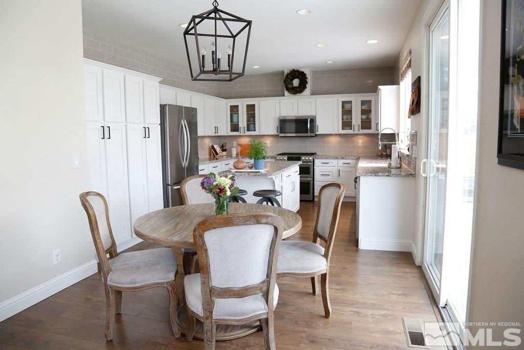 9841 Eastmont Court Reno, NV 89521 - Photo 5 of 38 a view of a dining room with furniture and a chandelier