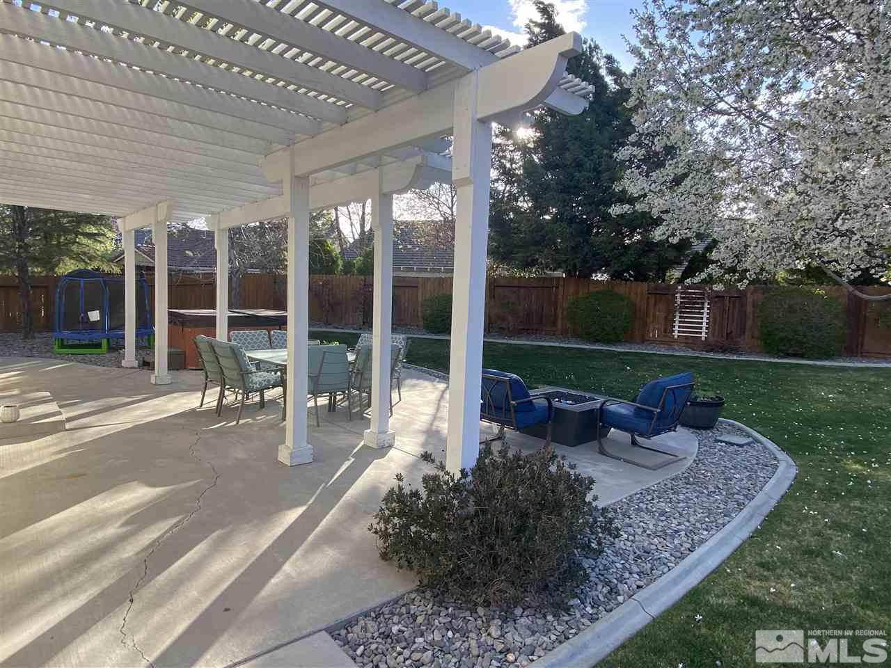 9841 Eastmont Court Reno, NV 89521 - Photo 10 of 38 a view of a patio with table and chairs potted plants with floor to ceiling window