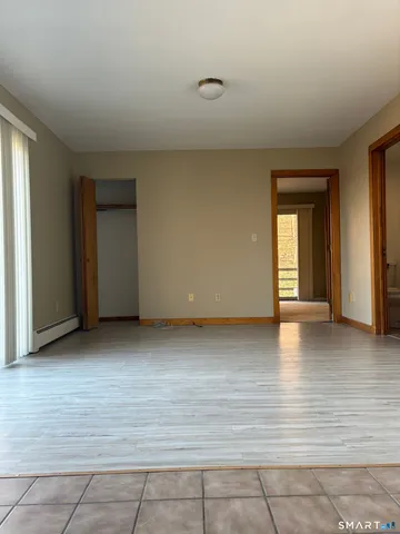 a view of a livingroom with wooden floor and a window