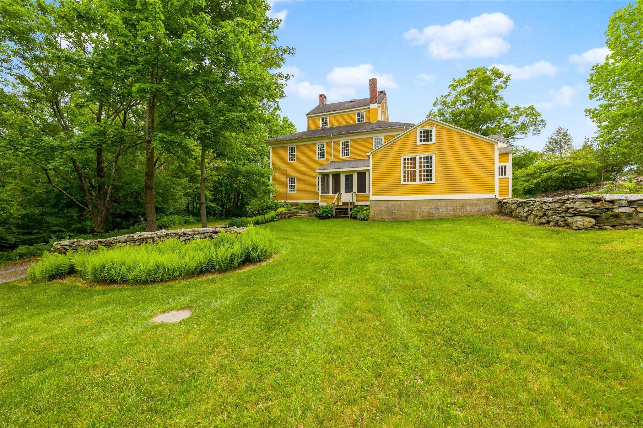 89 John Perry Road Eastford, CT 06242 - Photo 16 of 40 a view of a big house with a big yard and large trees
