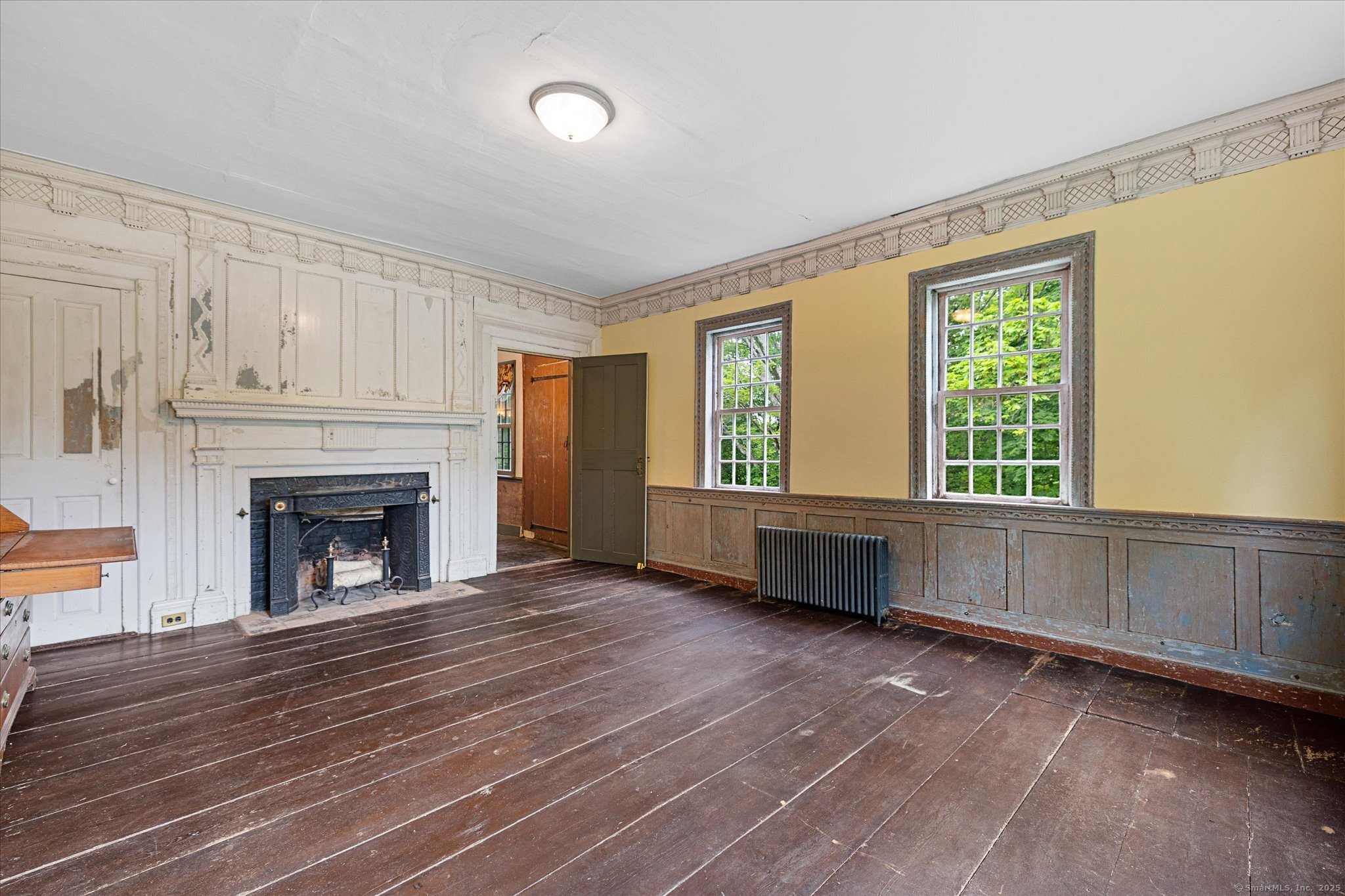 89 John Perry Road Eastford, CT 06242 - Photo 20 of 40 a view of an empty room with a window and fireplace