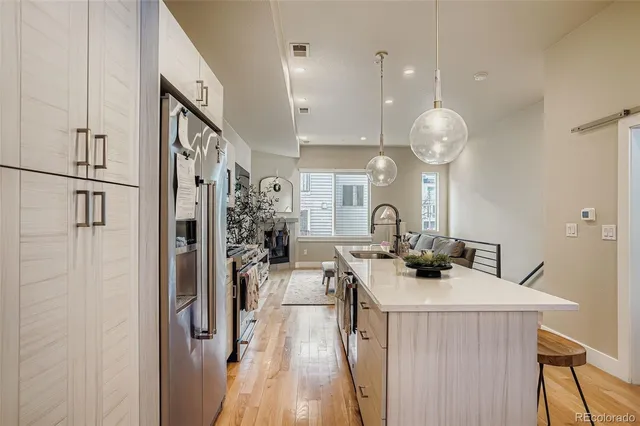 a view of a kitchen with a sink and refrigerator