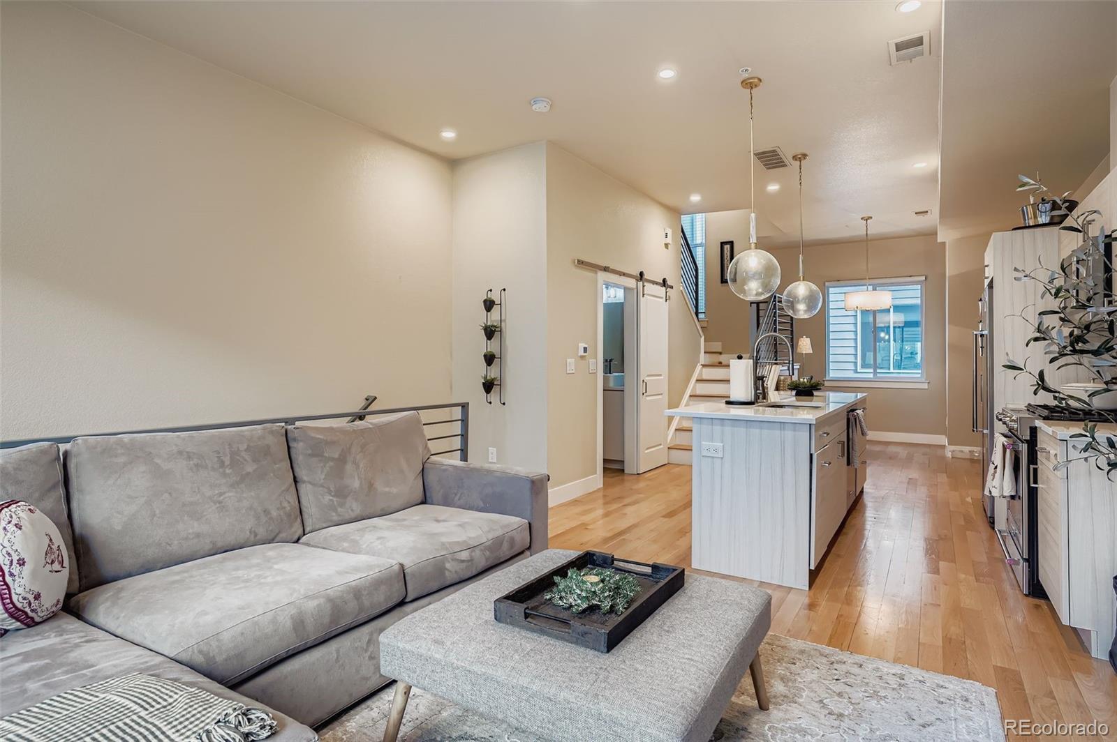 2739 West 24th Avenue, Unit 7 Denver, CO 80211 - Photo 16 of 31 a living room with furniture and a view of kitchen