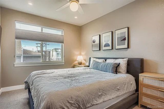 a bedroom with a large bed and a window