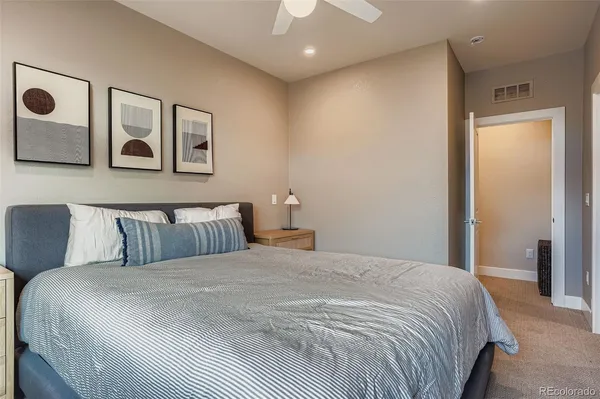 a bedroom with a large bed and a chandelier