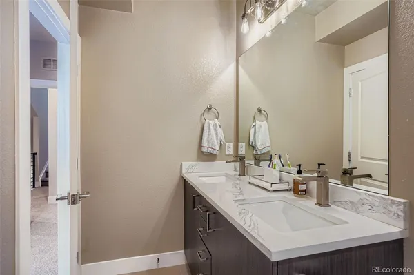 a kitchen with sink and mirror