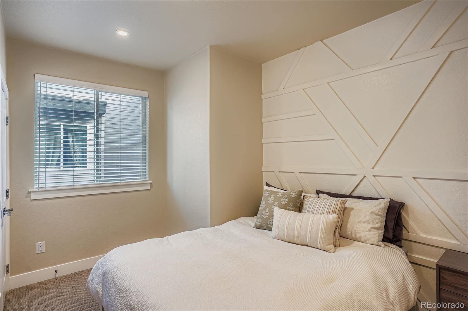 2739 West 24th Avenue, Unit 7 Denver, CO 80211 - Photo 21 of 31 a bedroom with a bed and a window