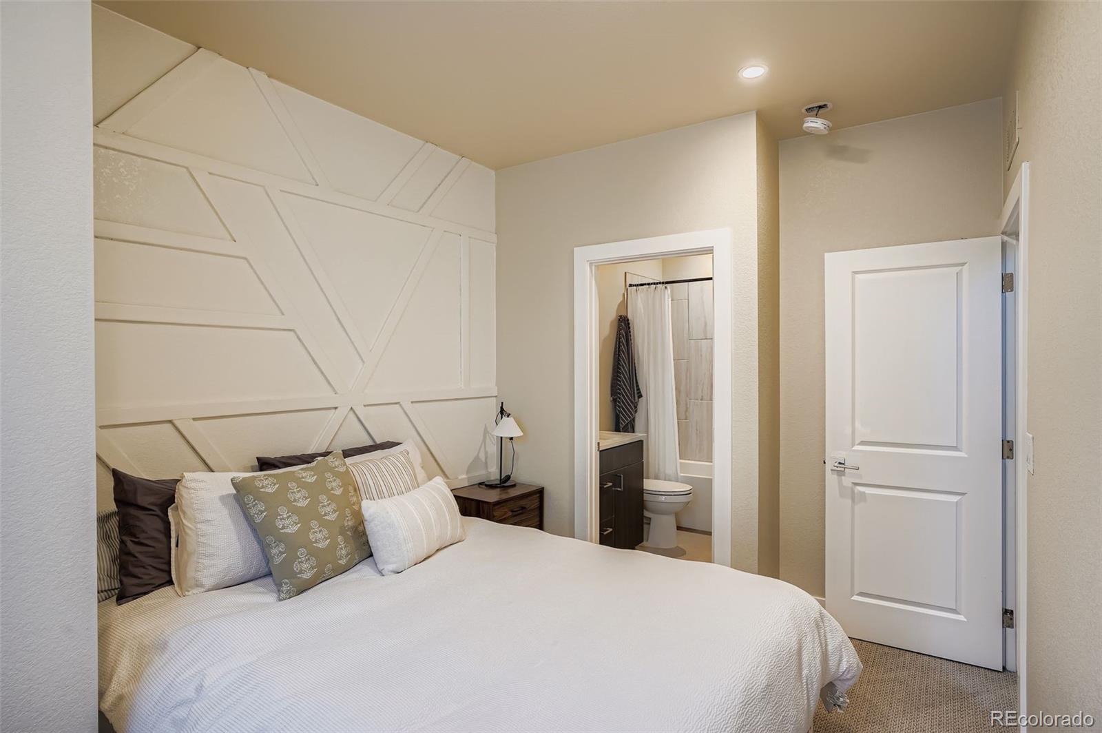 2739 West 24th Avenue, Unit 7 Denver, CO 80211 - Photo 22 of 31 a large bed in a white room