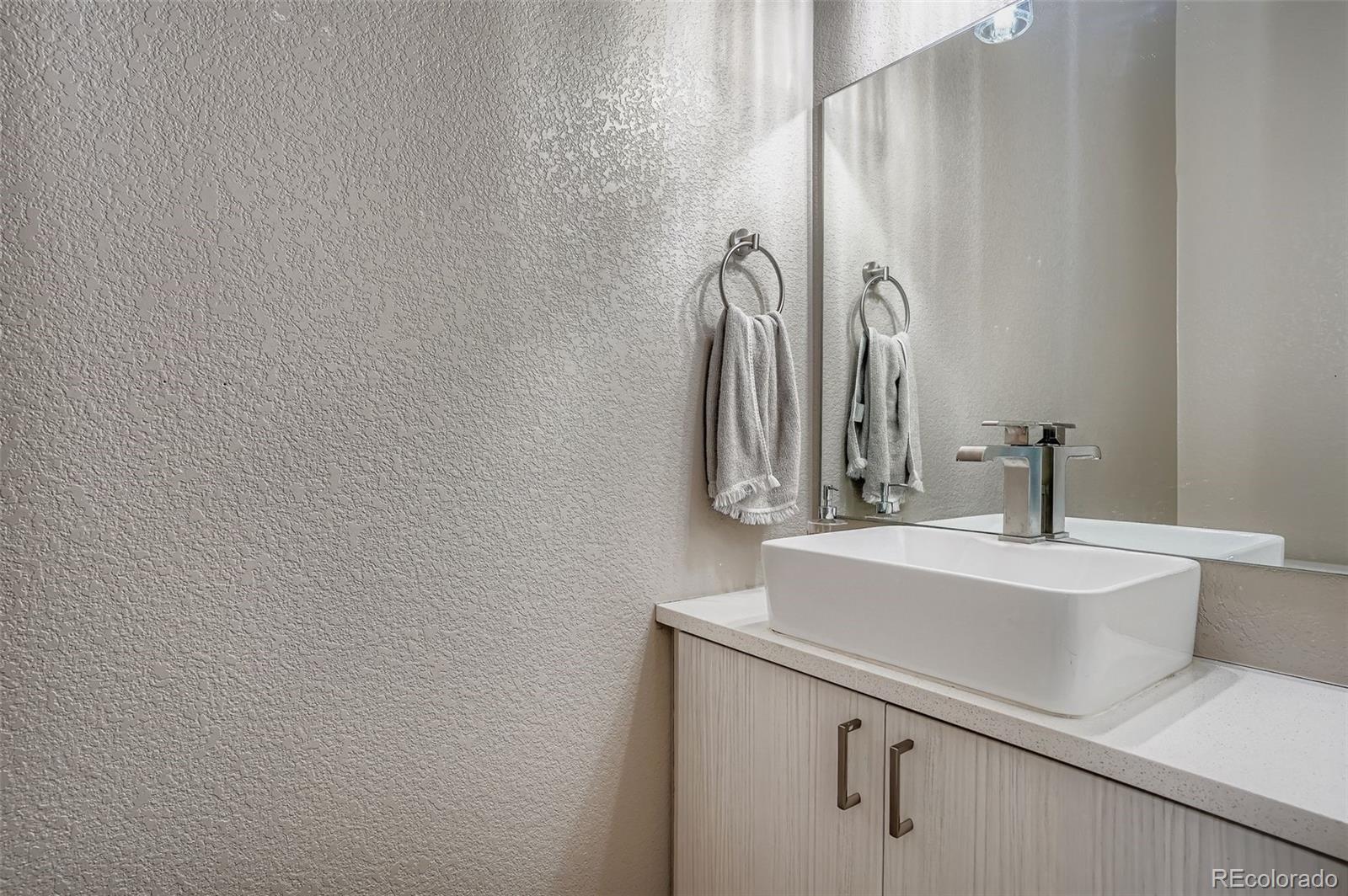 2739 West 24th Avenue, Unit 7 Denver, CO 80211 - Photo 8 of 31 a bathroom with a sink and a mirror
