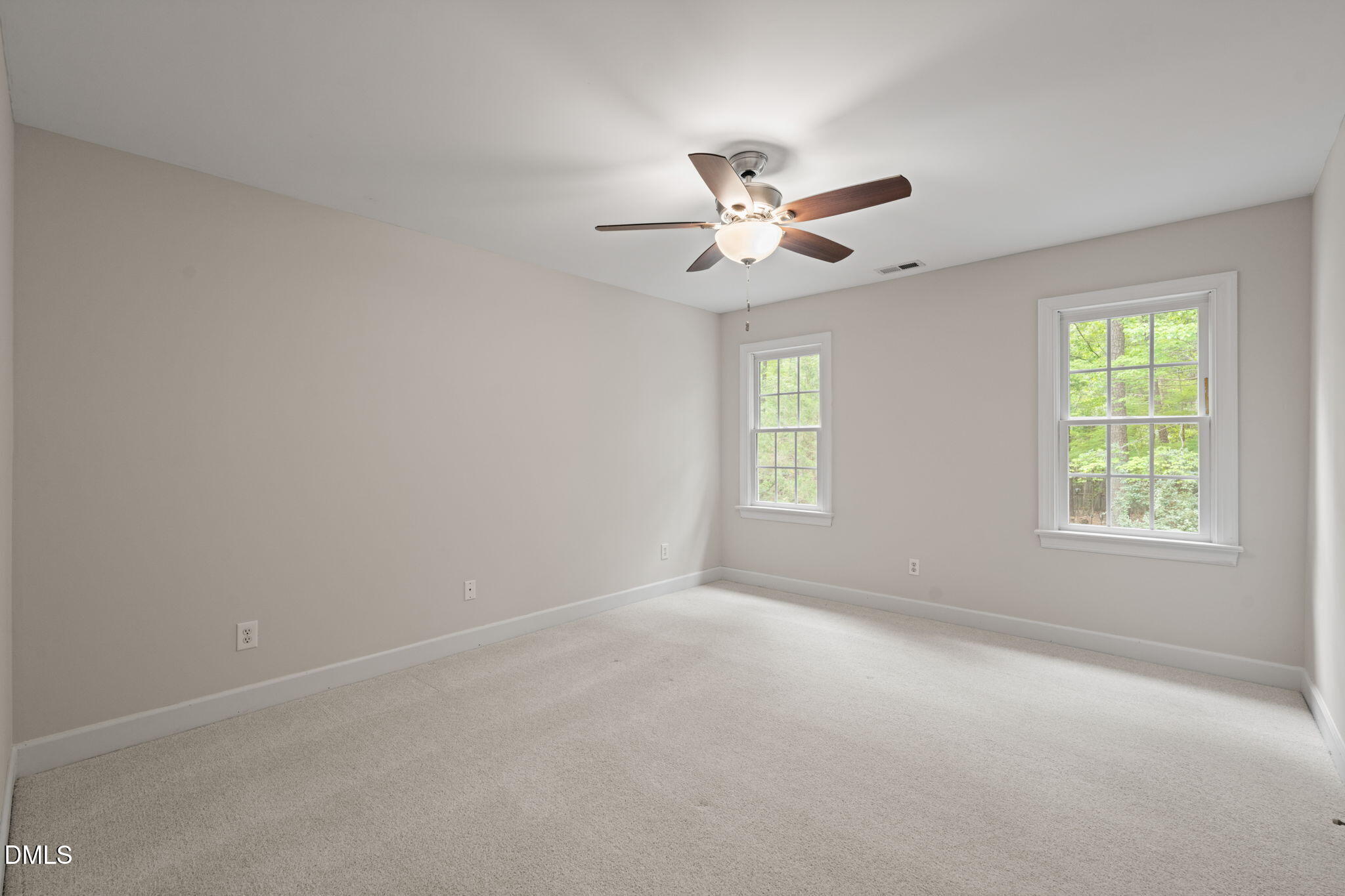 5809 Stone Spring Road Raleigh, NC 27613 - Photo 26 of 54 an empty room with a window and a fan