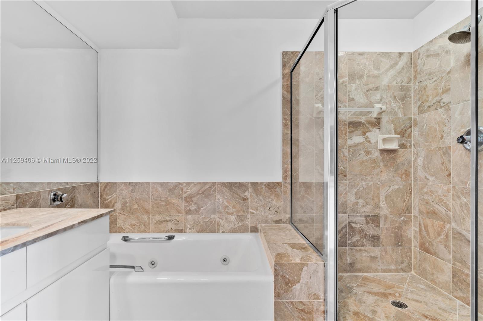 888 Brickell Key Drive, Unit 2610 Miami, FL 33131 - Photo 17 of 31 a bathroom with a bathtub and a sink