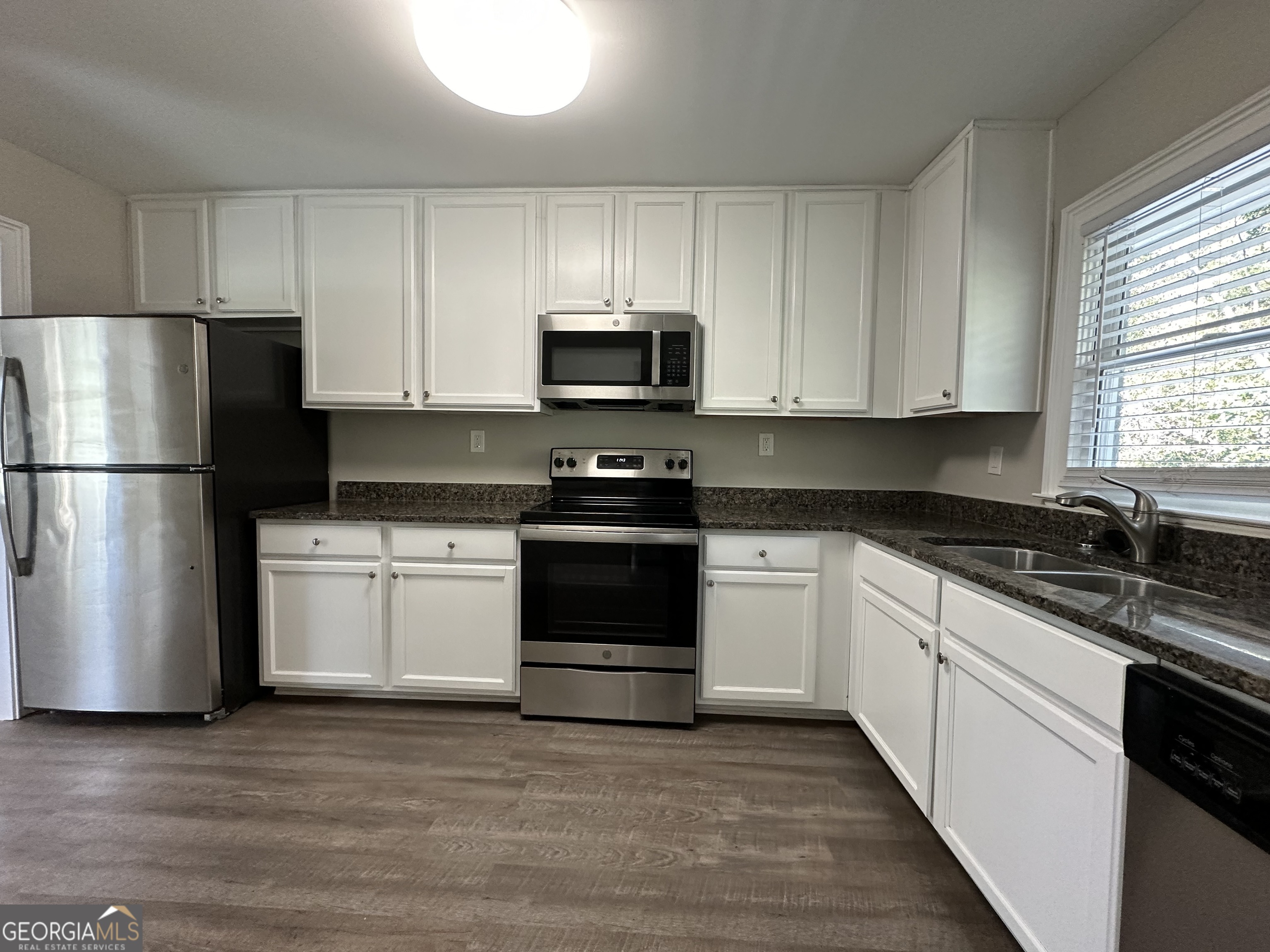 2164 Rockhaven Circle Decatur, GA 30032 - Photo 7 of 17 a kitchen with granite countertop a refrigerator stove and microwave