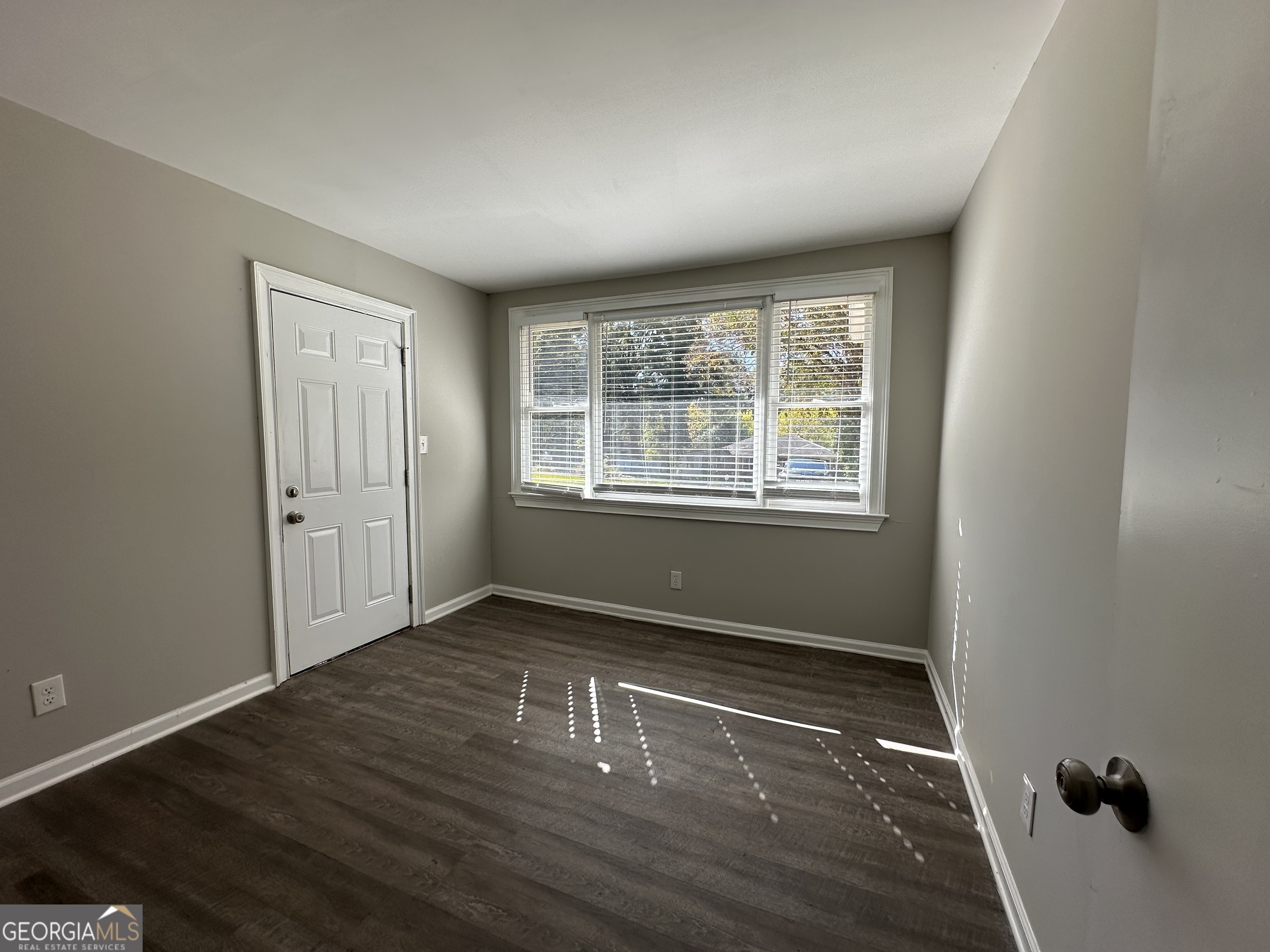 2164 Rockhaven Circle Decatur, GA 30032 - Photo 8 of 17 an empty room with wooden floor and windows