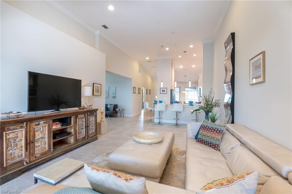 9419 Benvenuto Court, Unit 204 Naples, FL 34119 - Photo 30 of 50 Living room with ornamental molding, recessed lighting, light tile patterned floors, and a towering ceiling