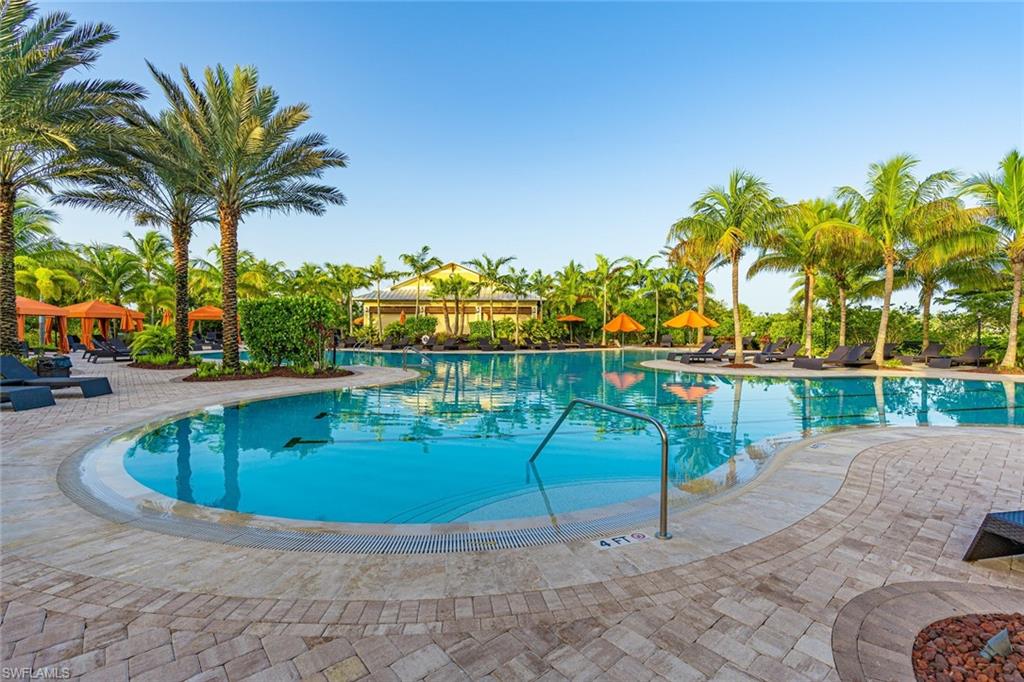 9419 Benvenuto Court, Unit 204 Naples, FL 34119 - Photo 4 of 50 Community pool featuring a patio area