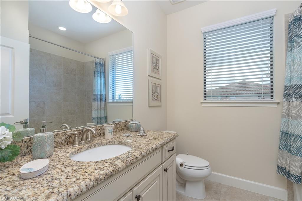 9419 Benvenuto Court, Unit 204 Naples, FL 34119 - Photo 41 of 50 Full bath with vanity, light tile patterned floors, and a shower with curtain
