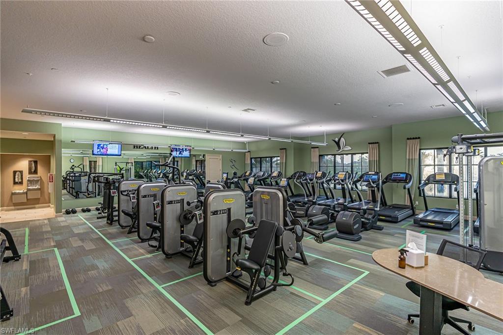 9419 Benvenuto Court, Unit 204 Naples, FL 34119 - Photo 9 of 50 Workout area featuring carpet floors and a textured ceiling