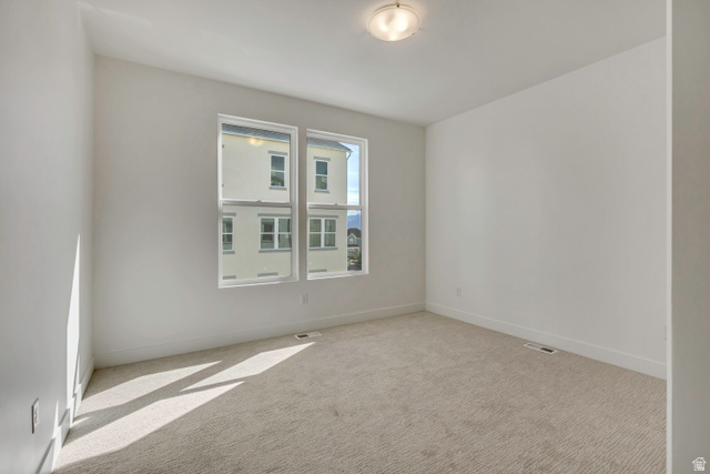 10999 South Freestone Road, Unit 111 South Jordan, UT 84009 - Photo 7 of 13 Spare room with carpet floors and baseboards