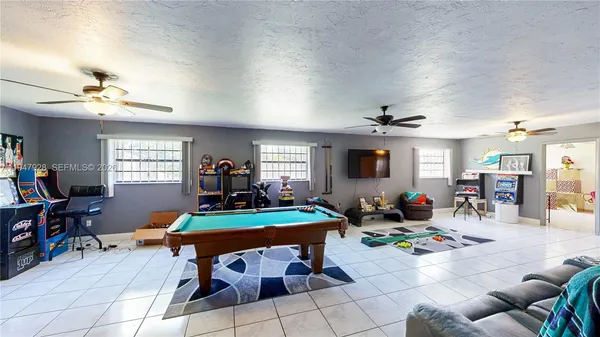 a living room with furniture and a gym
