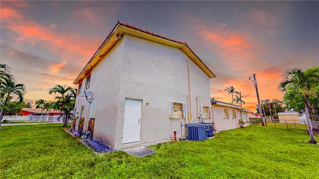 a view of an house with backyard space and garden