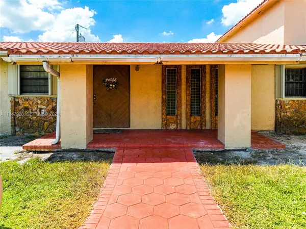 a view of a house with large windows