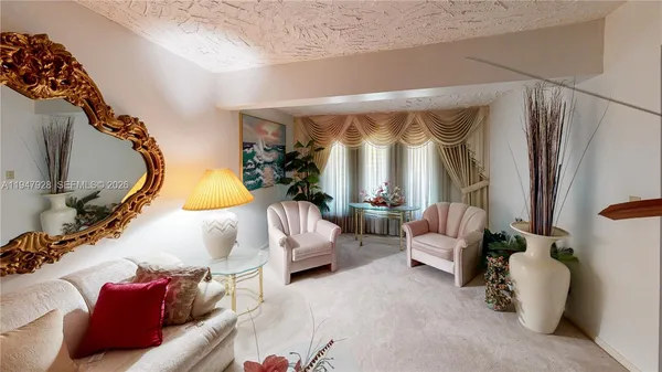a dining room with stainless steel appliances kitchen island granite countertop a stove and a refrigerator