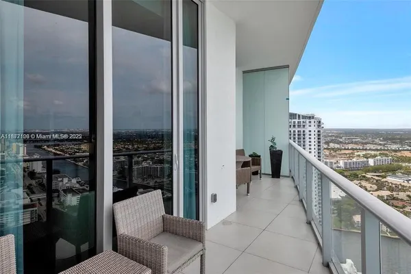 a large bedroom with a large bed and a flat screen tv