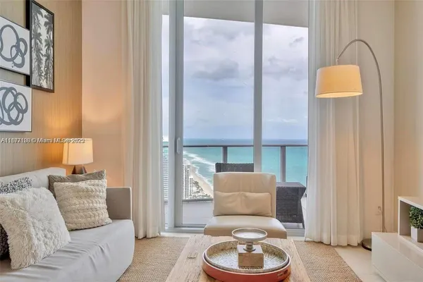 a kitchen with stainless steel appliances kitchen island a stove a table and chairs in it