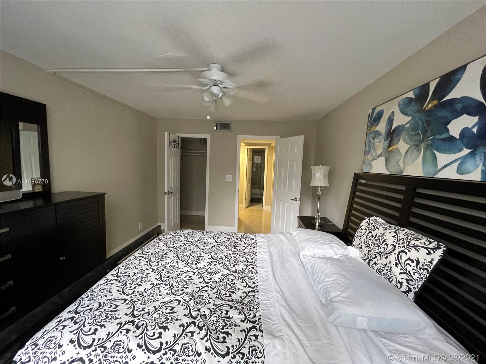 6700 Cypress Road, Unit 105 Plantation, FL 33317 - Photo 11 of 26 a bedroom with a bed and a television