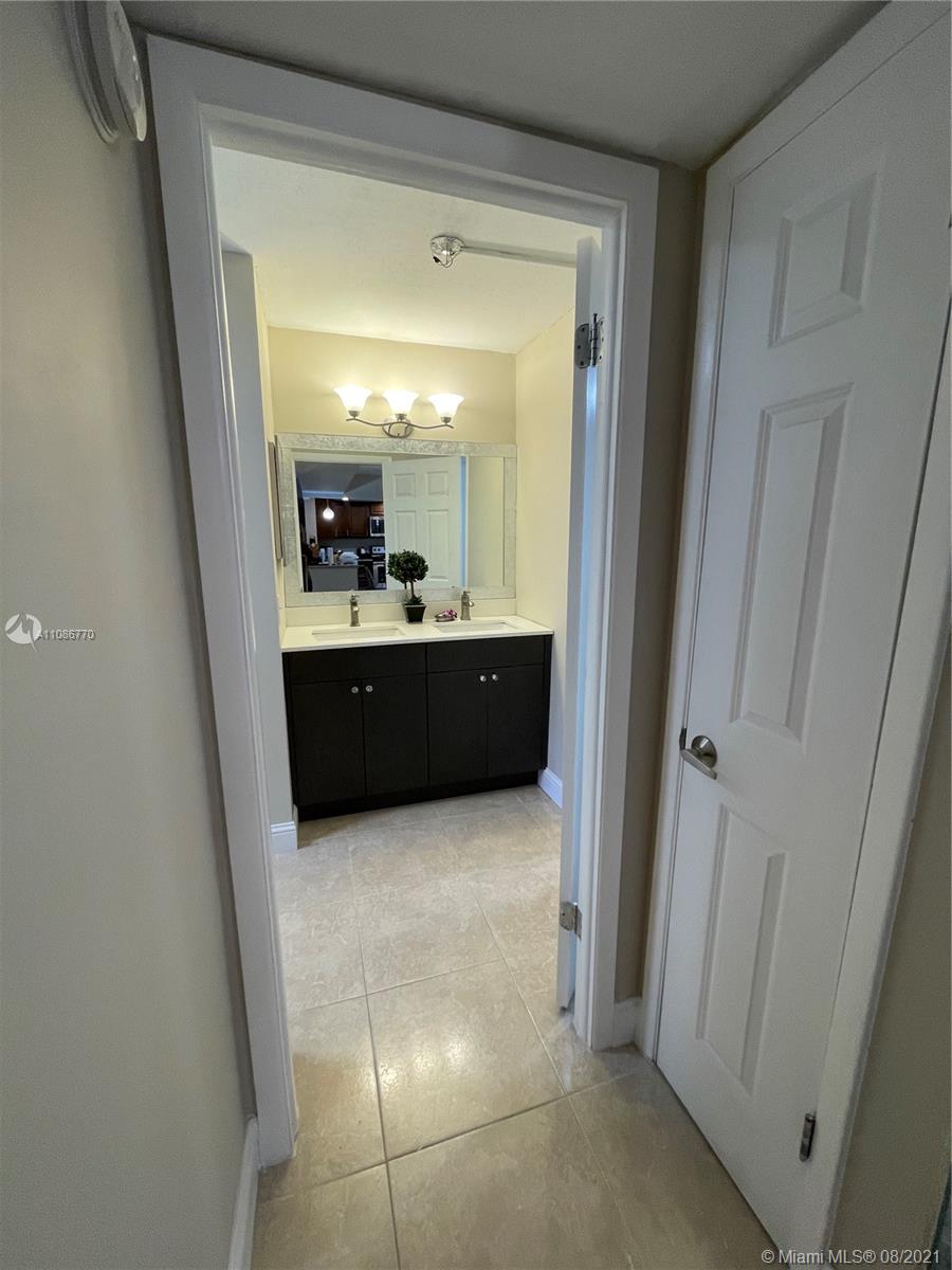 6700 Cypress Road, Unit 105 Plantation, FL 33317 - Photo 13 of 26 a view of a bathroom from a corridor