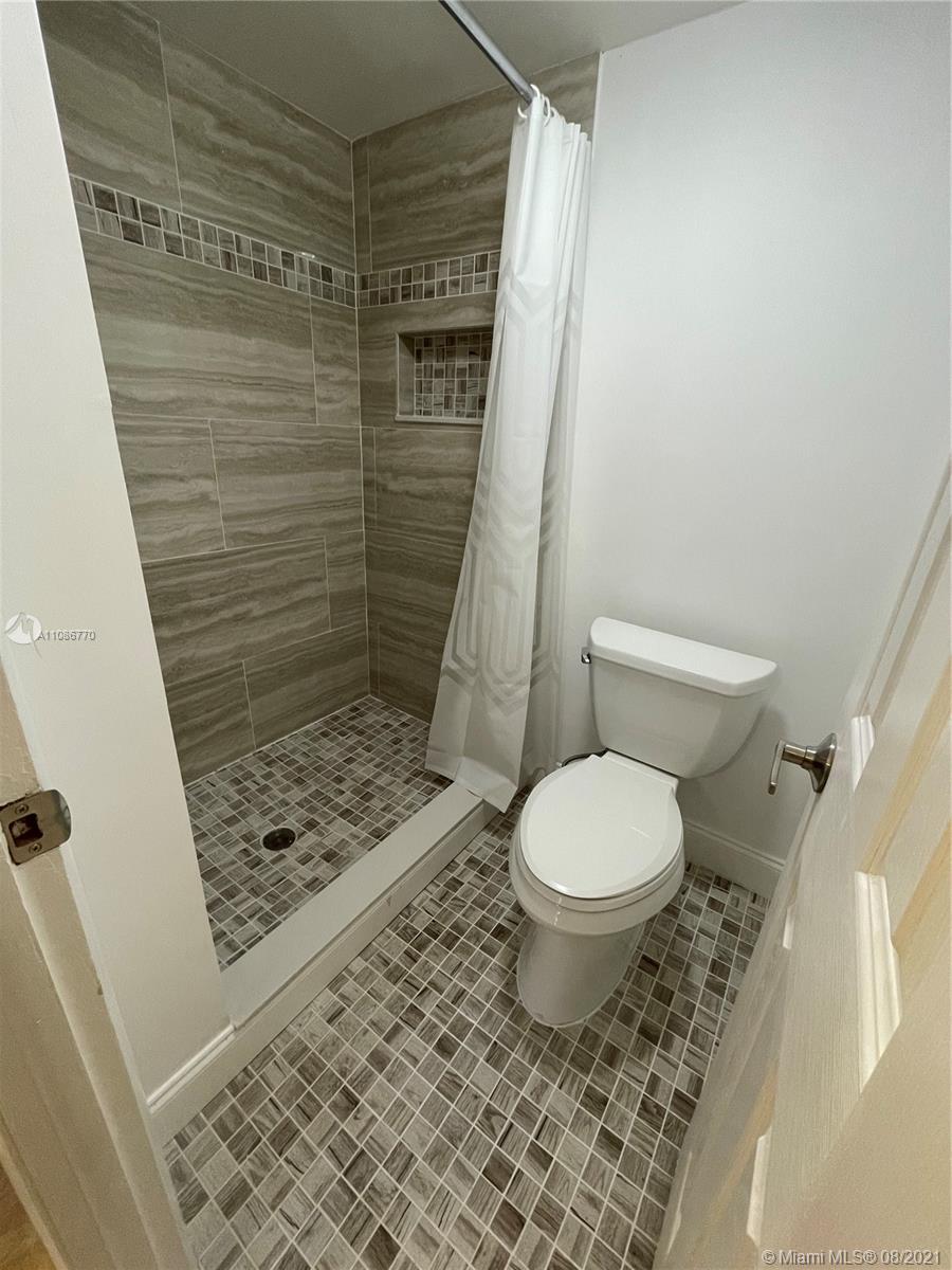 6700 Cypress Road, Unit 105 Plantation, FL 33317 - Photo 15 of 26 a bathroom with a toilet and a shower