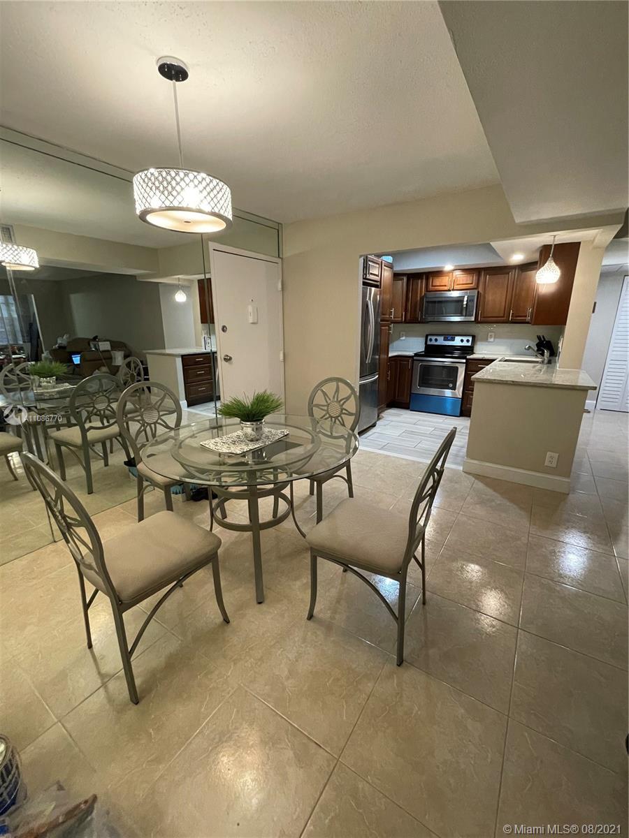 6700 Cypress Road, Unit 105 Plantation, FL 33317 - Photo 3 of 26 a view of a livingroom with furniture and a flat screen tv