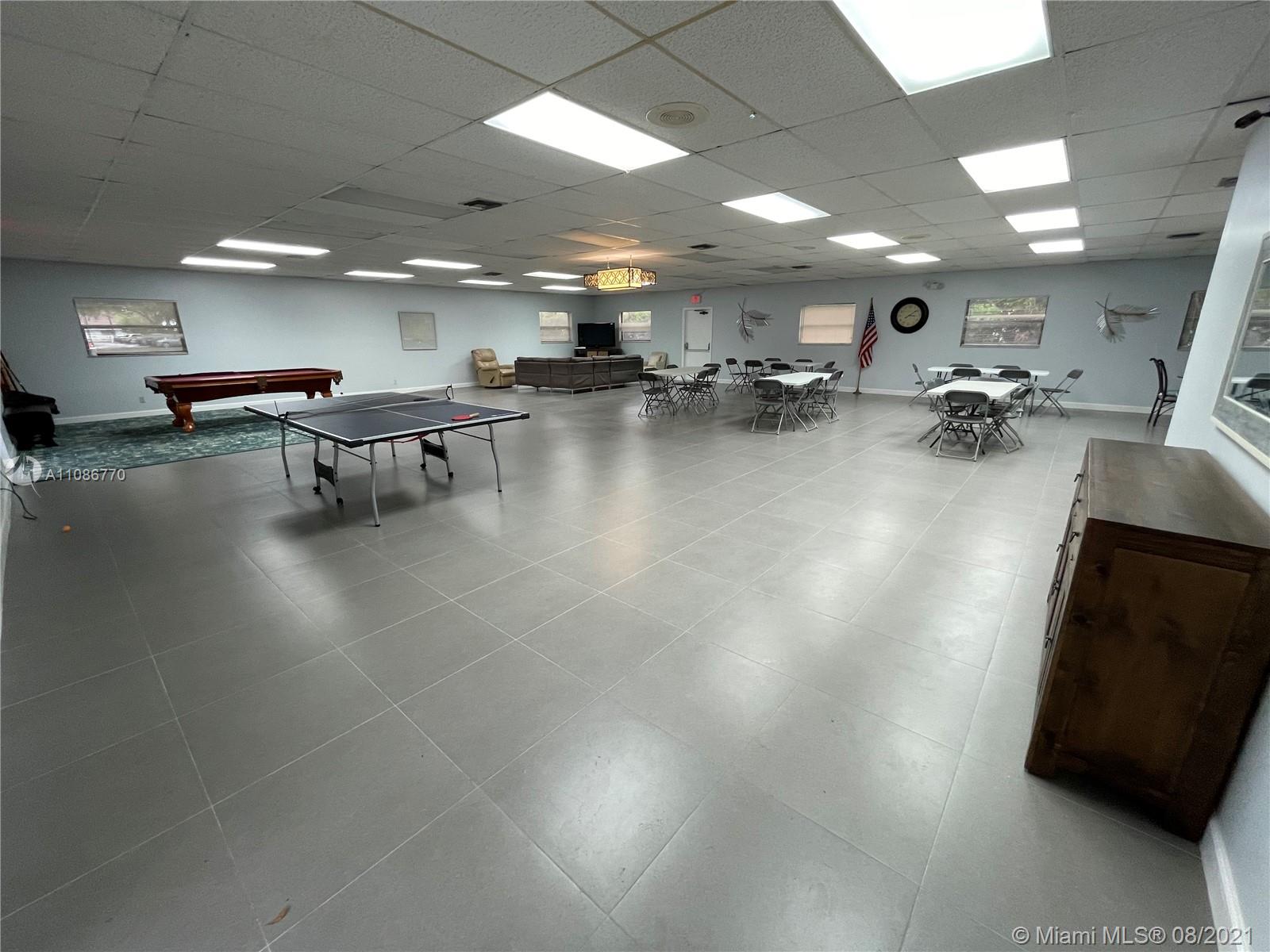 6700 Cypress Road, Unit 105 Plantation, FL 33317 - Photo 21 of 26 a gym room with lots of furniture and a table