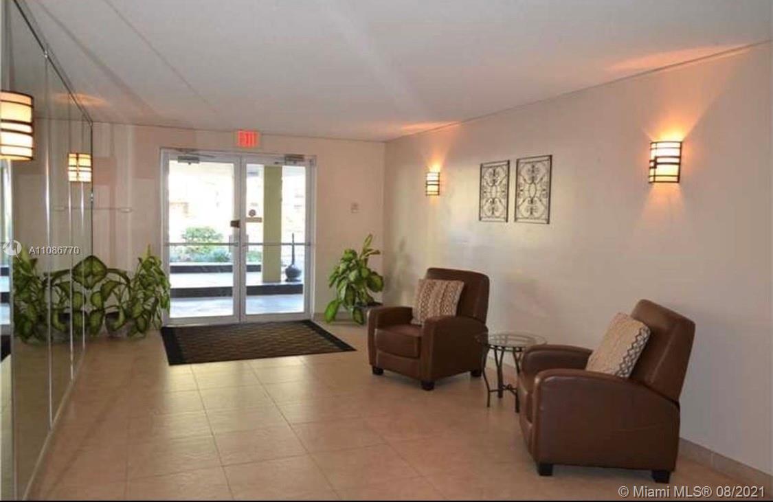 6700 Cypress Road, Unit 105 Plantation, FL 33317 - Photo 23 of 26 a lobby with furniture and floor to ceiling window