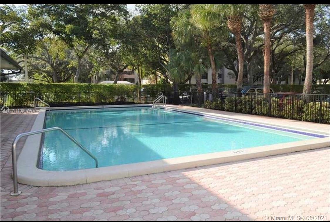 6700 Cypress Road, Unit 105 Plantation, FL 33317 - Photo 24 of 26 a view of a swimming pool with a yard