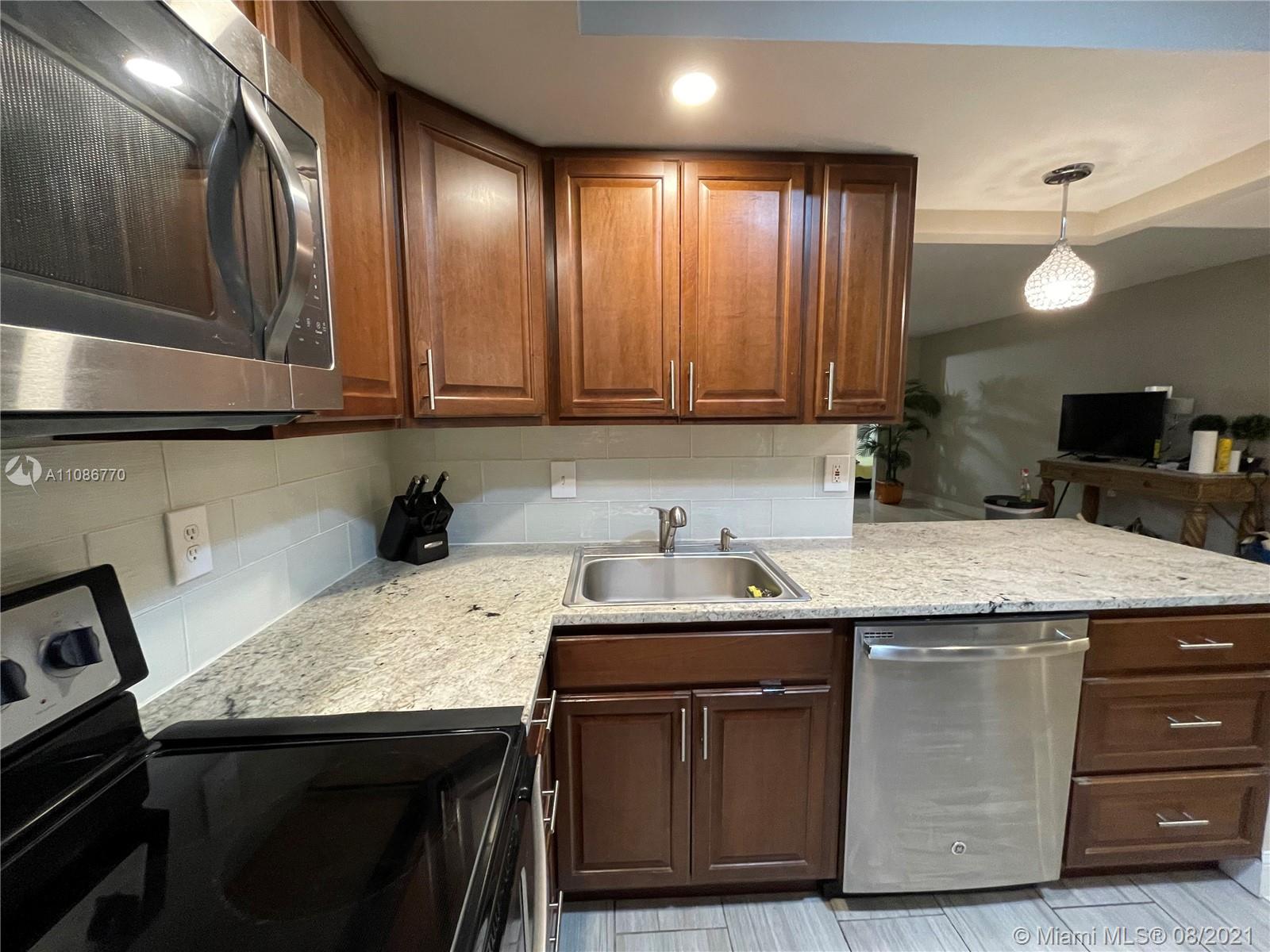 6700 Cypress Road, Unit 105 Plantation, FL 33317 - Photo 4 of 26 a kitchen with a sink and cabinets