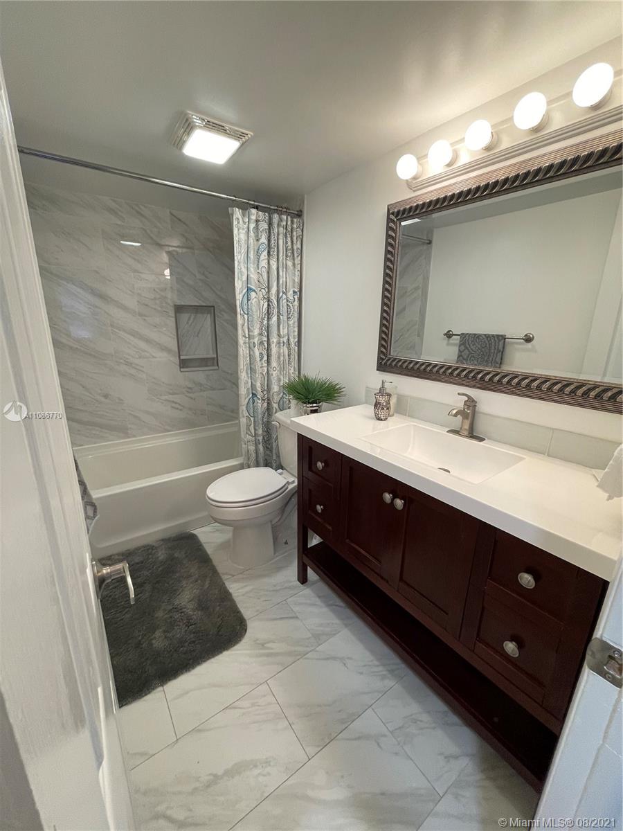 6700 Cypress Road, Unit 105 Plantation, FL 33317 - Photo 10 of 26 a bathroom with a sink vanity mirror and toilet