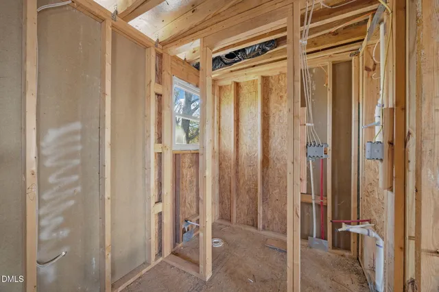 a view of a hallway with wooden cabinets and staircase