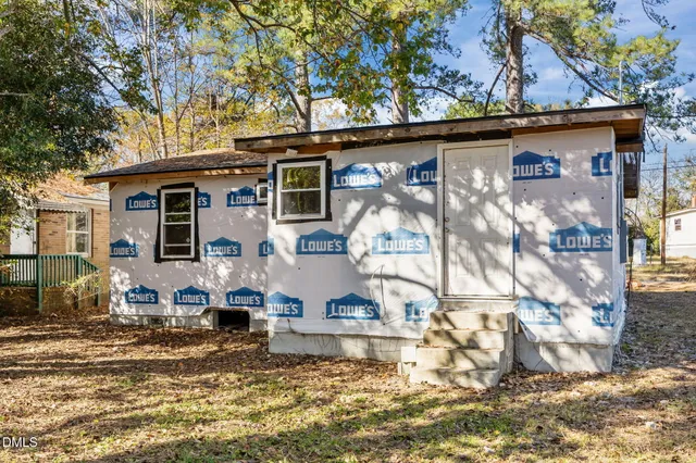 a front view of a house with sitting area